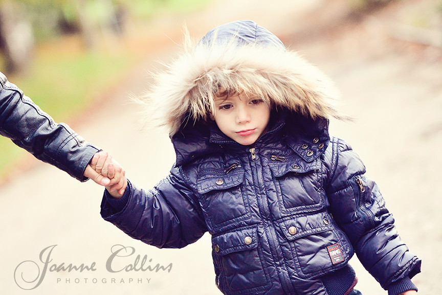 onlocation photography cute boy with fur hood holding mums hand mote park maidstone kent
