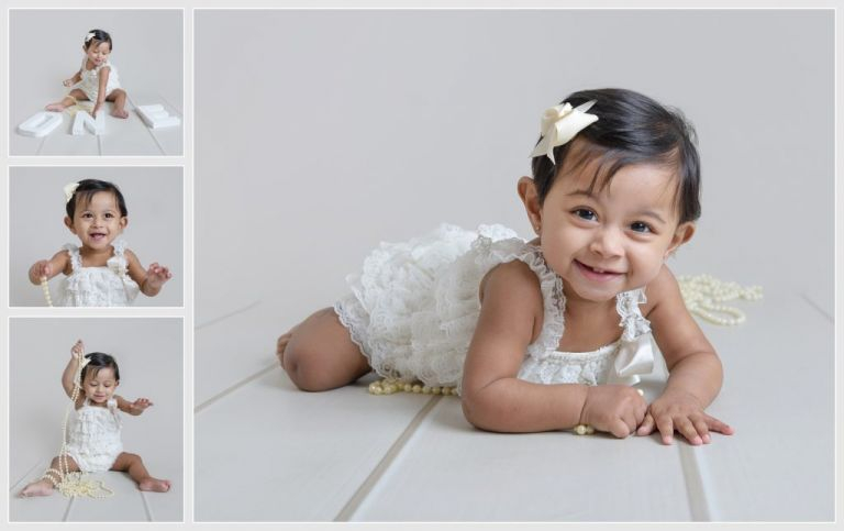 first birthday photoshoot kent. Baby girl in frilly romper