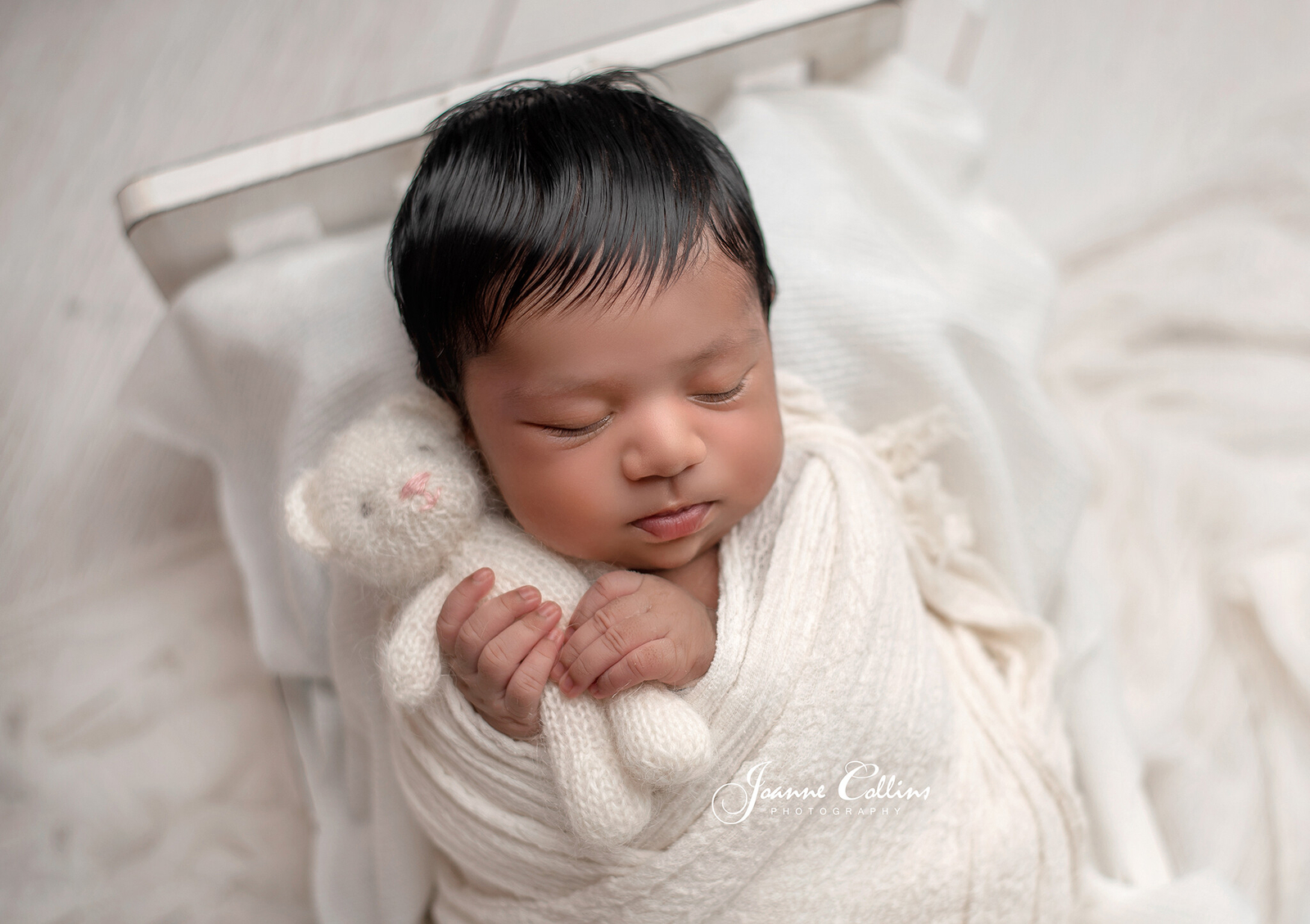 newborn photographer sittingbourne baby girl 9 days new cuddling teddy