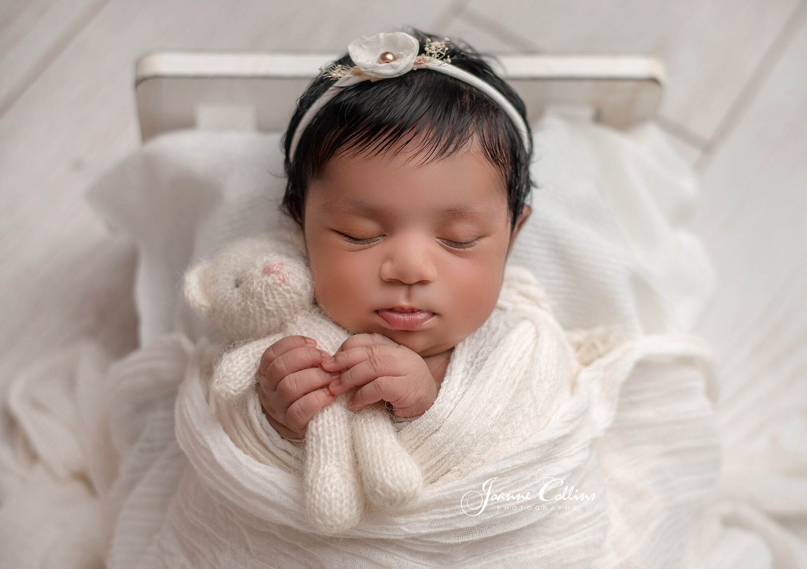 newborn photographer sittingbourne baby girl 9 days new in cute white bed